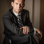 intense, functional background, semi seated, dark, formal